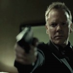 Kiefer Sutherland in The Confession pointing gun