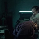 Kiefer Sutherland in The Confession beating guy