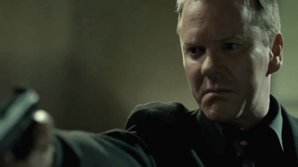 Kiefer Sutherland in The Confession pointing gun