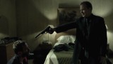 Kiefer Sutherland in The Confession pointing gun