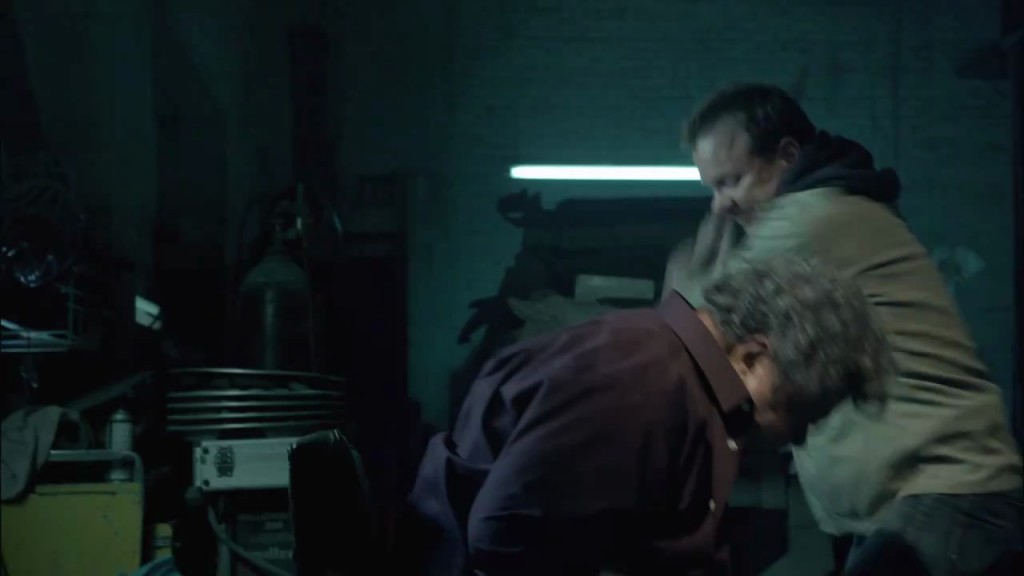 Kiefer Sutherland in The Confession beating guy