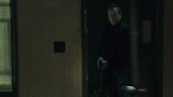 Kiefer Sutherland in The Confession kicking down door holding gun