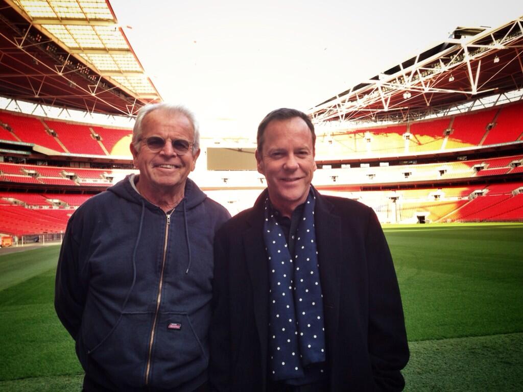 William Devane and Kiefer Sutherland pose for a photo in Wembley Stadium while filming 24: Live Another Day